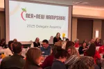 An image of NEA-NH President Megan Tuttle leading the 2025 Delegate Assembly. 