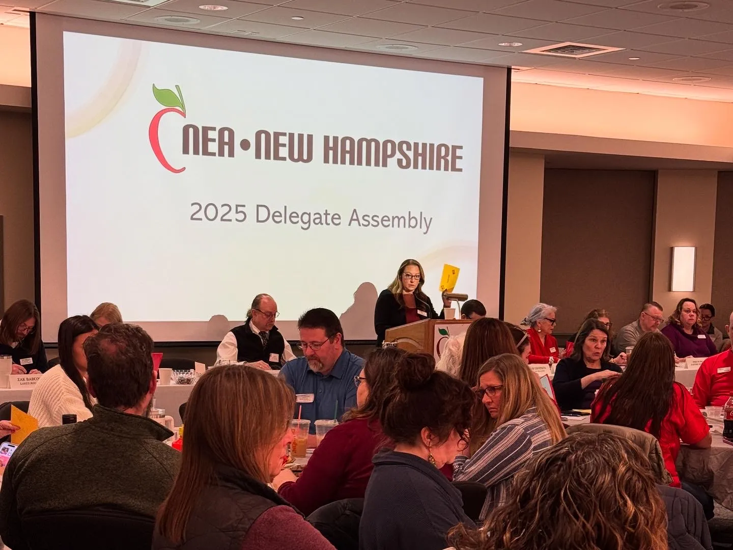 An image of NEA-NH President Megan Tuttle leading the 2025 Delegate Assembly. 