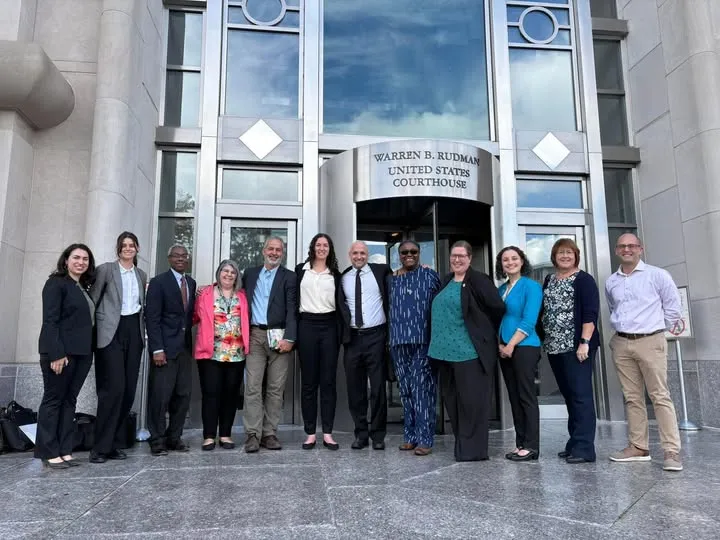 Plaintiffs stand in front of the US District Courthouse
