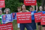 member demonstration with signs that read, "Great public school are a basic human right for every child"