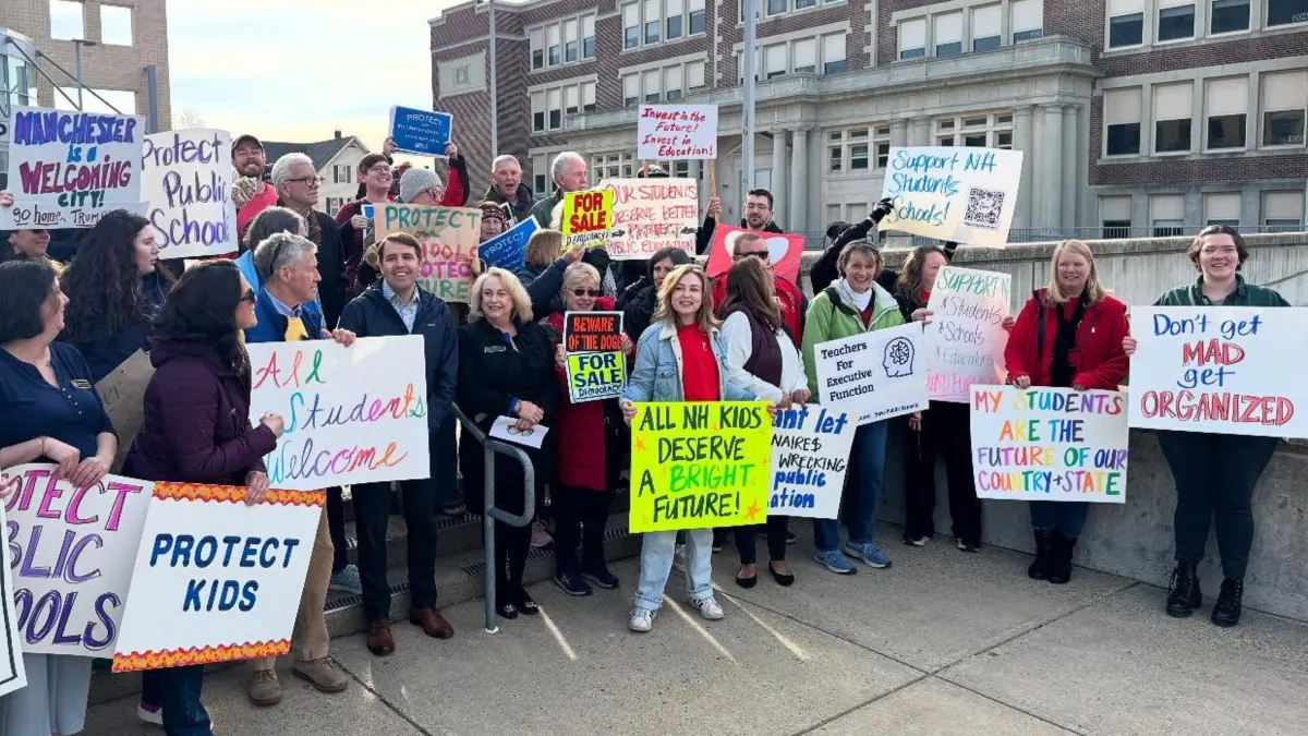 Members at walk-in with signs - one sign reads, _all NH kids deserve a bright future