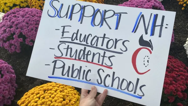 An image of a poster that reads "Support NH: Educators; Students; Public Schools" with mums in the background.